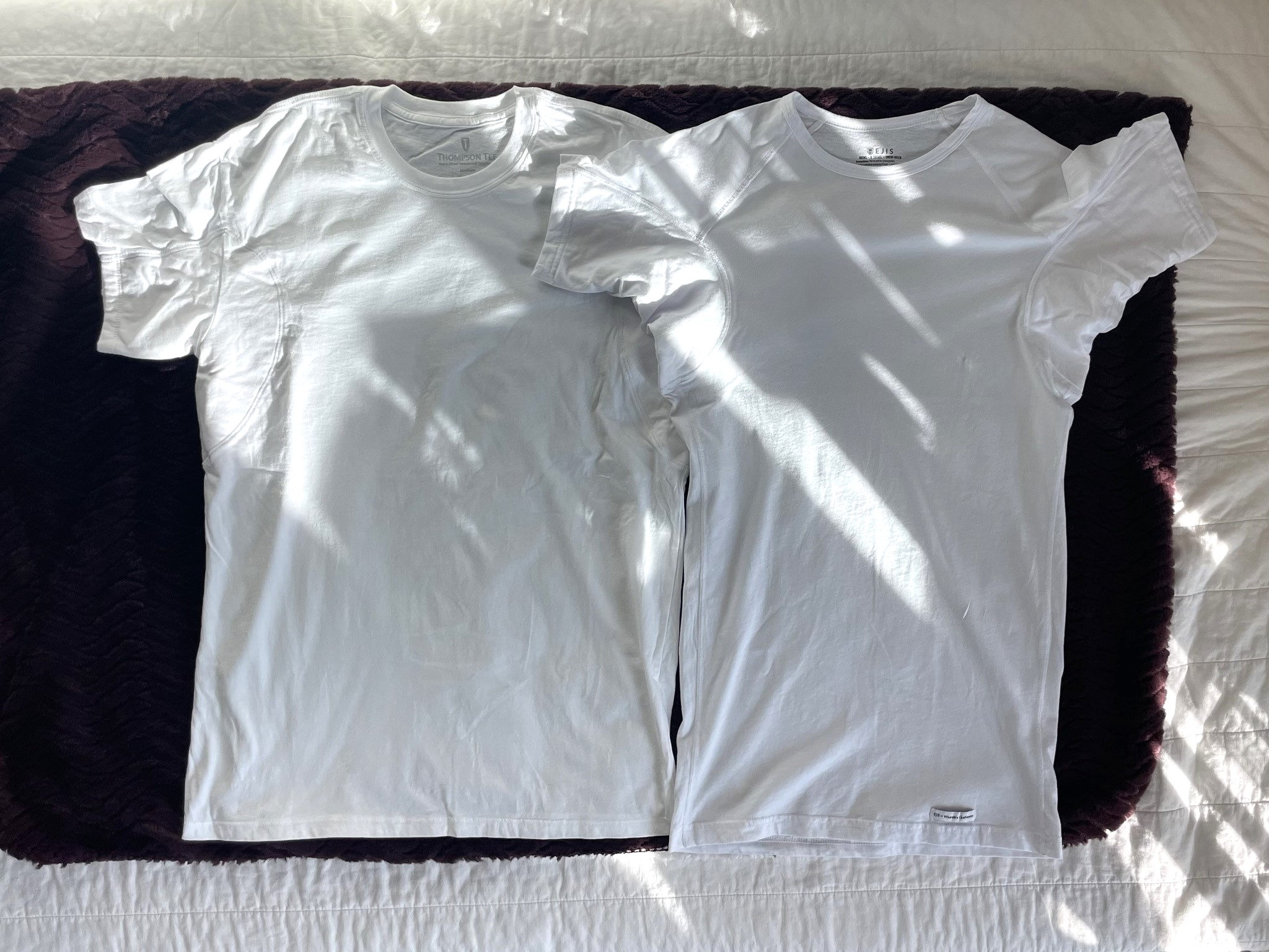 Pictured on the left is a medium size Thompson Tee vs an extra small size Ejis on the right. Despite the two-size difference, Ejis is still longer.