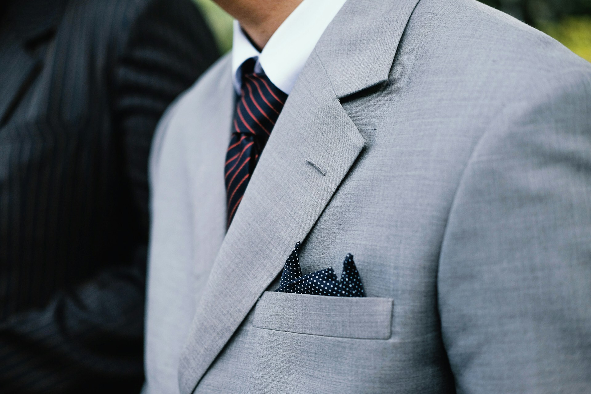 Man wearing a suit with a stylish tie and pocket square